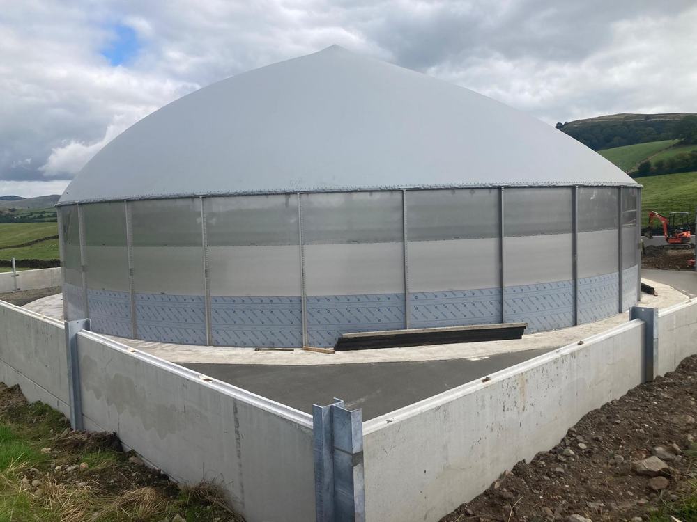 A completed digester with dome roof on its finished concrete base