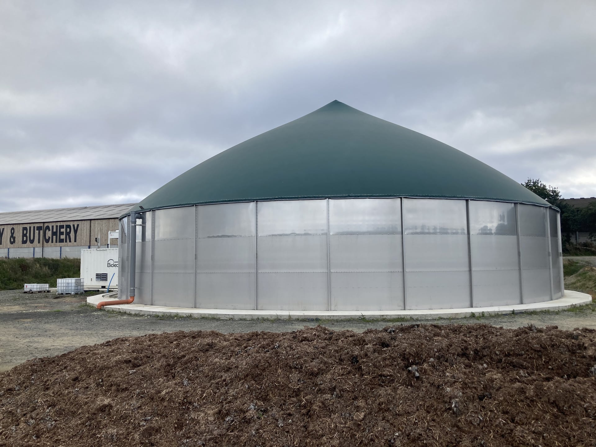Close-up of a completed green-domed digester tank