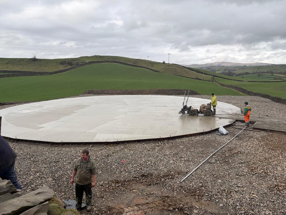 On site during groundworks for an anaerobic digestion installation, with the concrete pad being power-floated