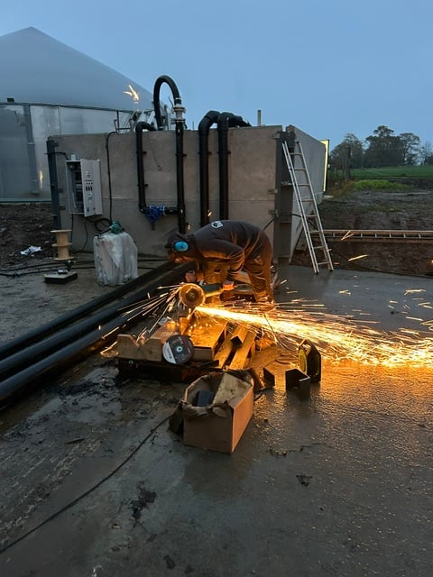 Cutting fusion pipework on site during the build