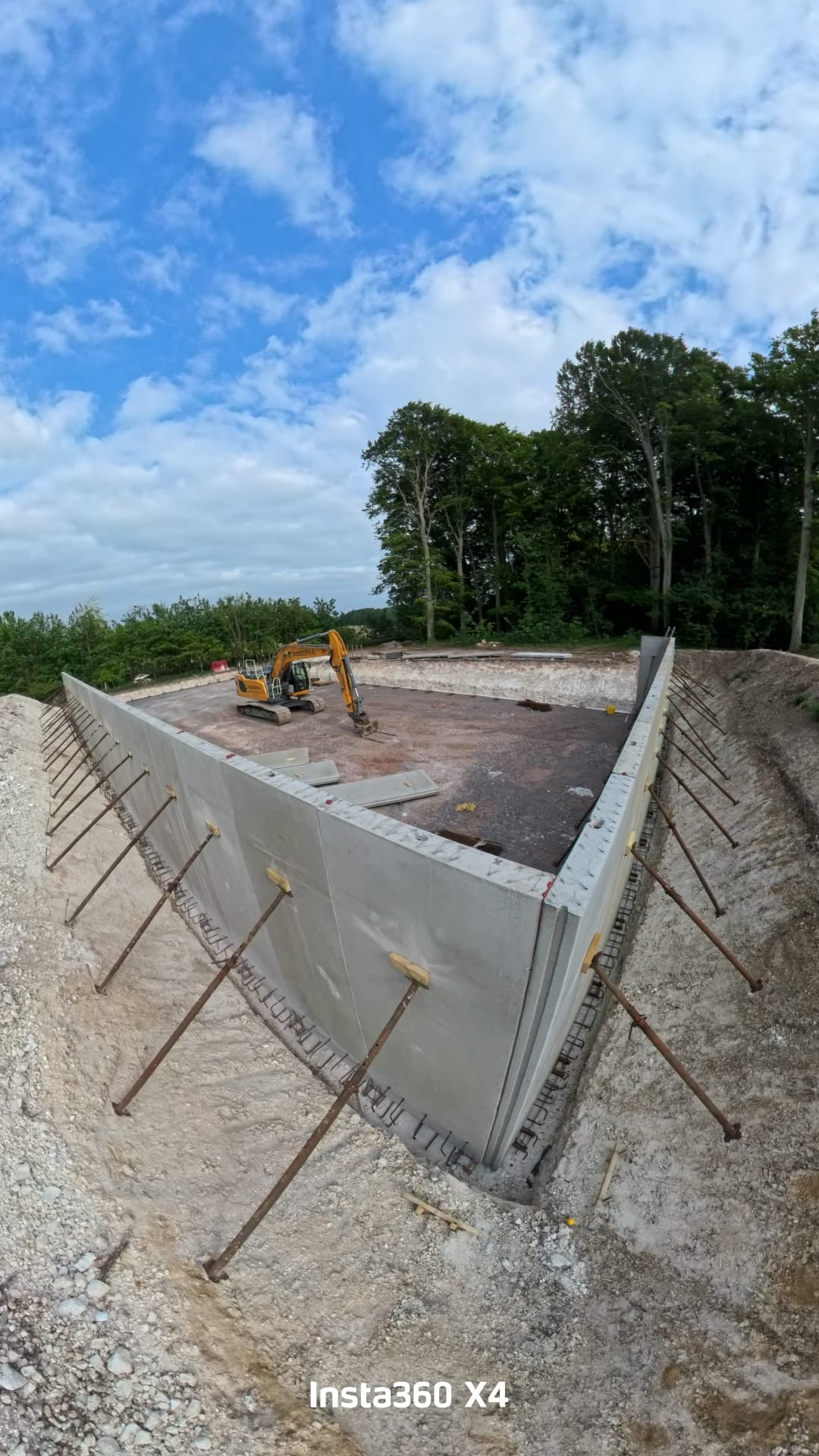 A rectangular concrete tank under construction, with formwork panels in place