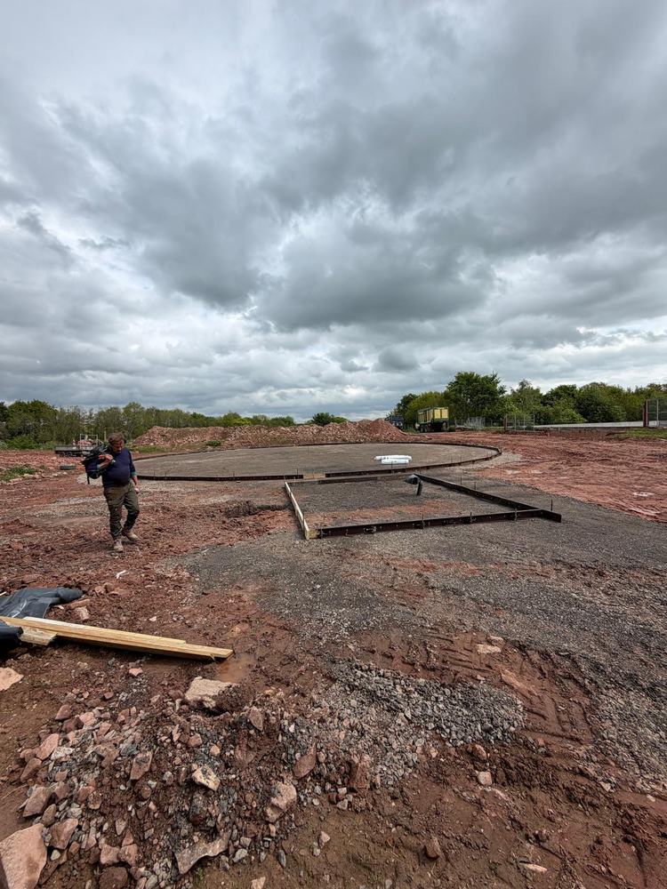 Reviewing a freshly marked-out concrete pad ahead of plant installation